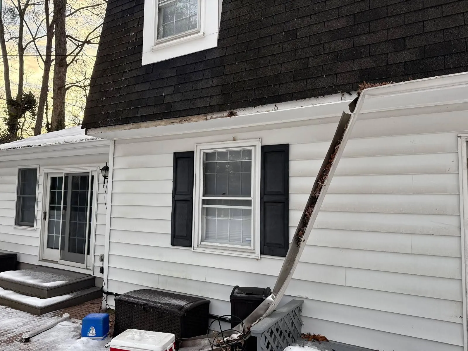 Gutter section pulled loose from the fascia and packed with leaves on a Maryland home